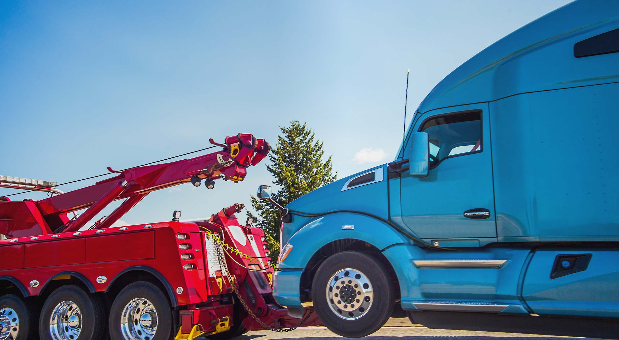 Semi truck being towed by a tow truck